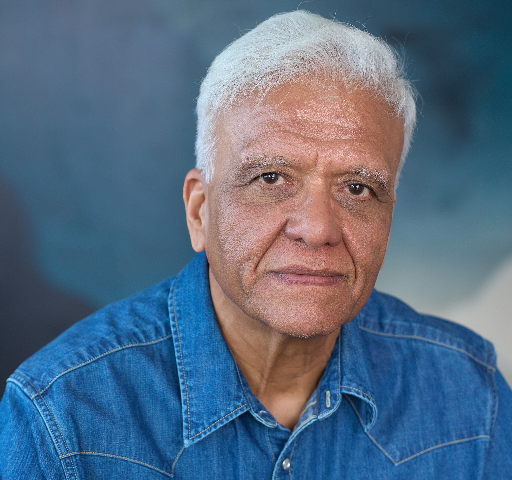 Upinder Raisauda in a grounded character headshot wearing denim