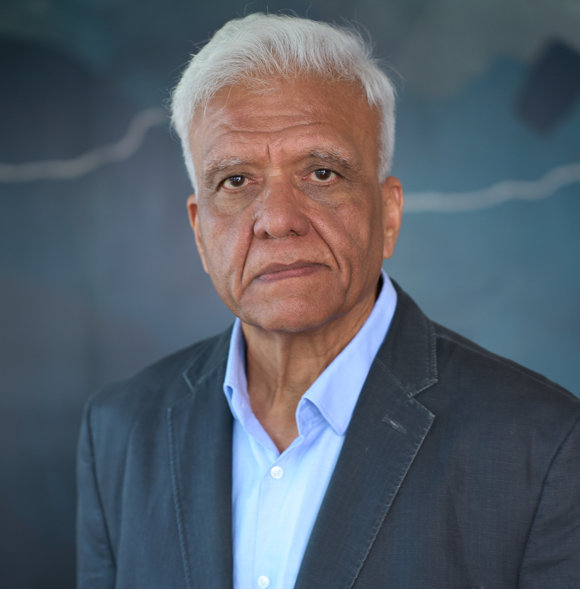 Upinder Raisauda in a composed professional headshot wearing a dark jacket